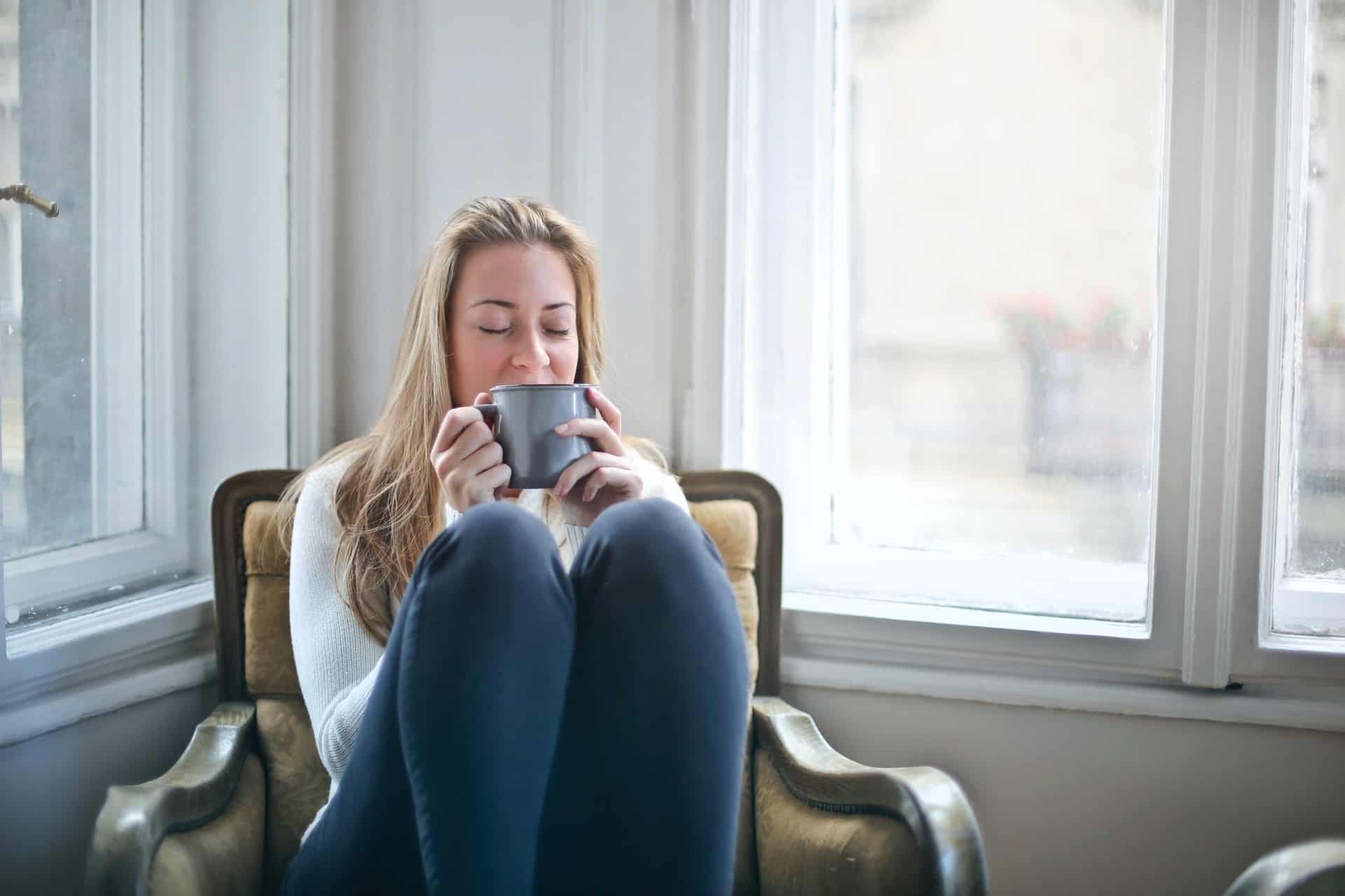 Woman holding gray mug 