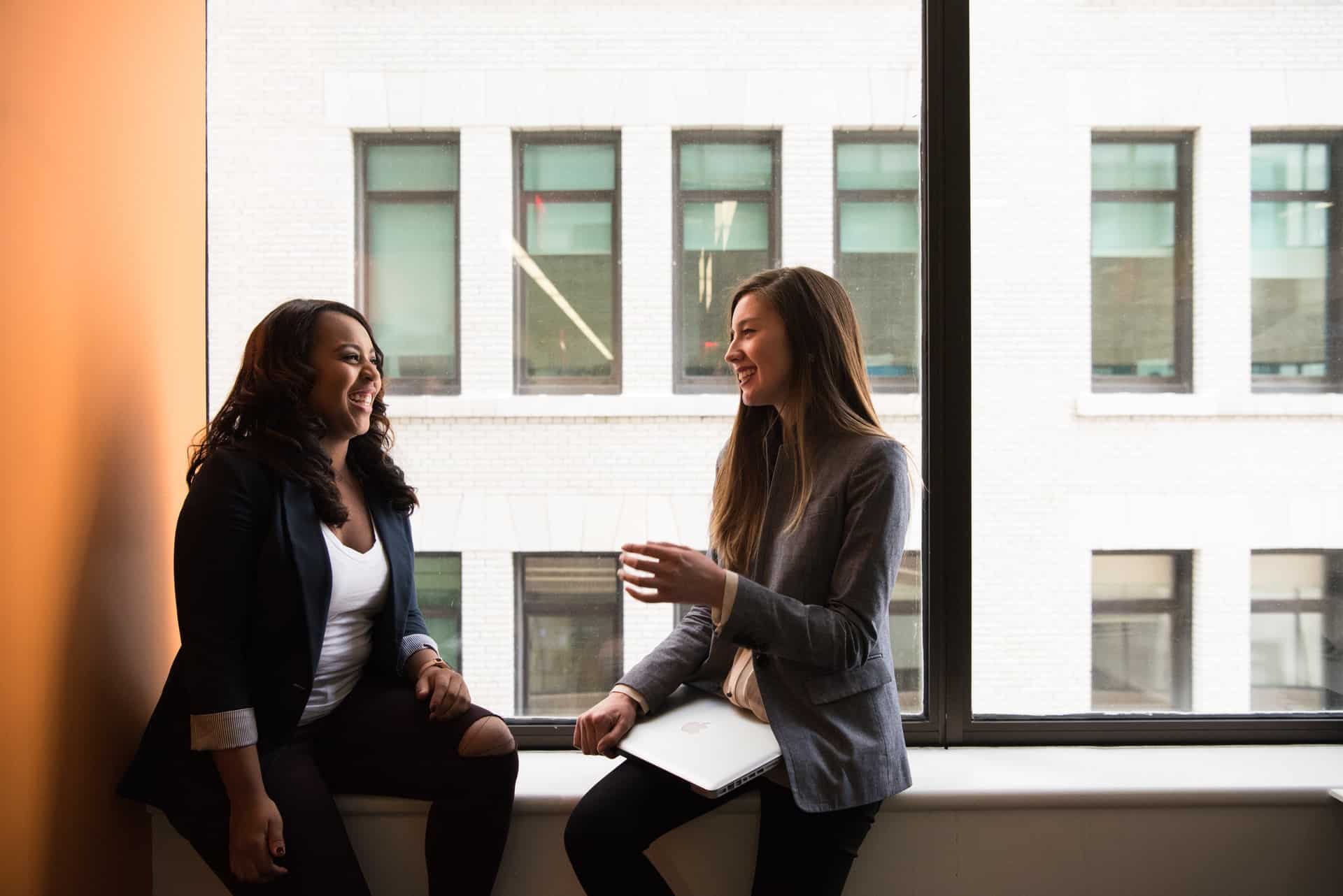 Women sitting on window ledge