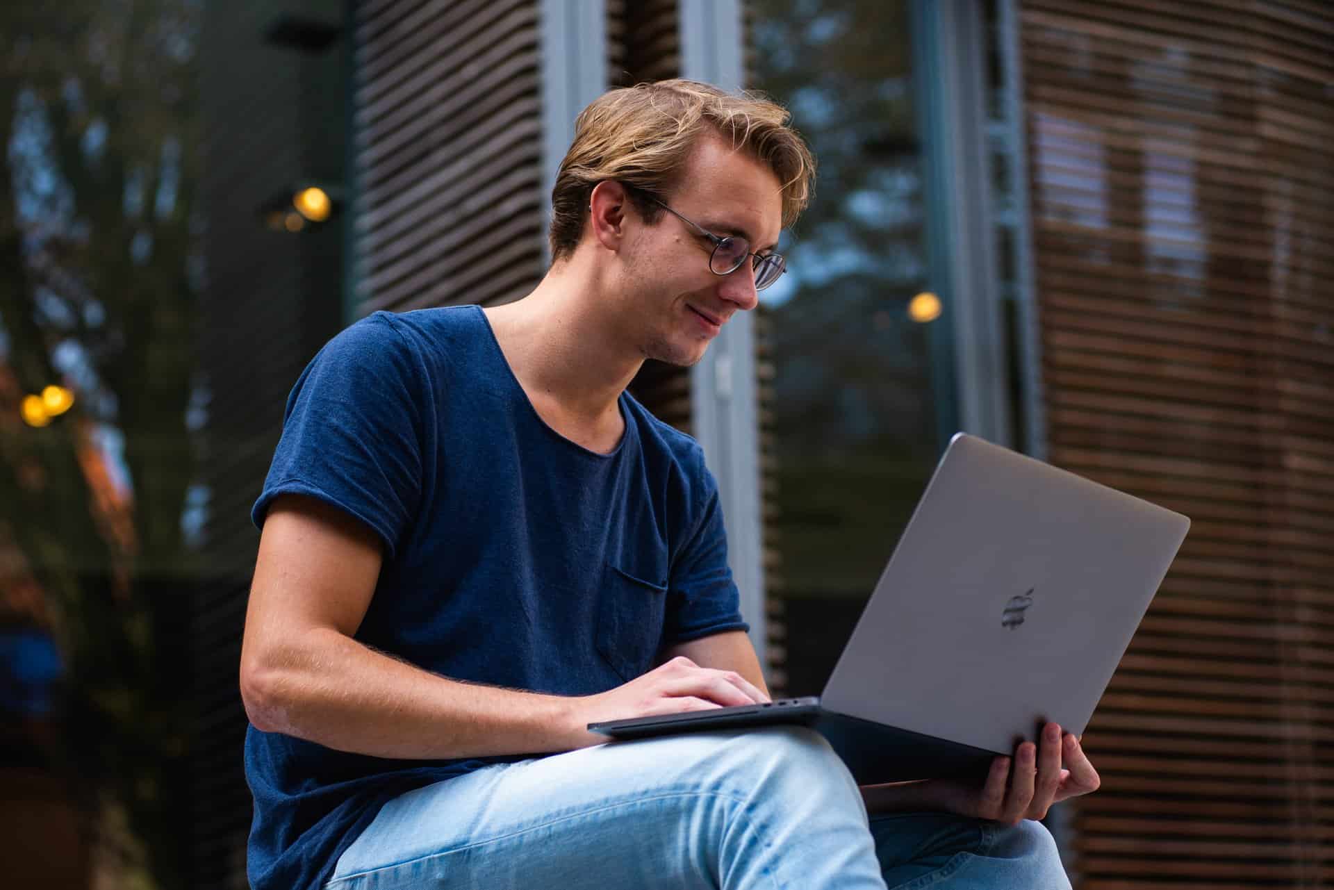 Man happily using laptop