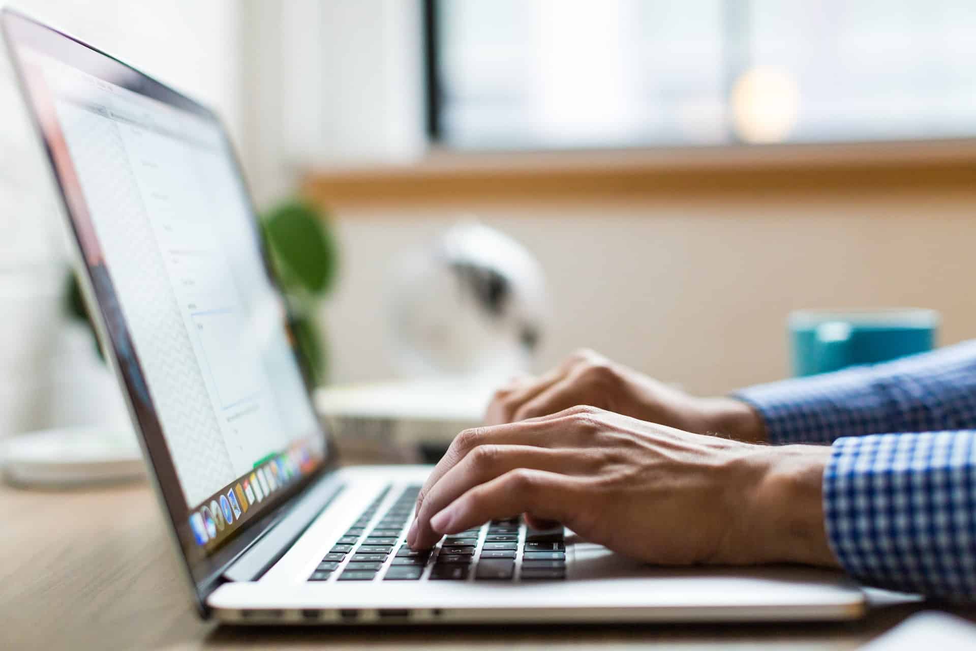 Worker typing on laptop