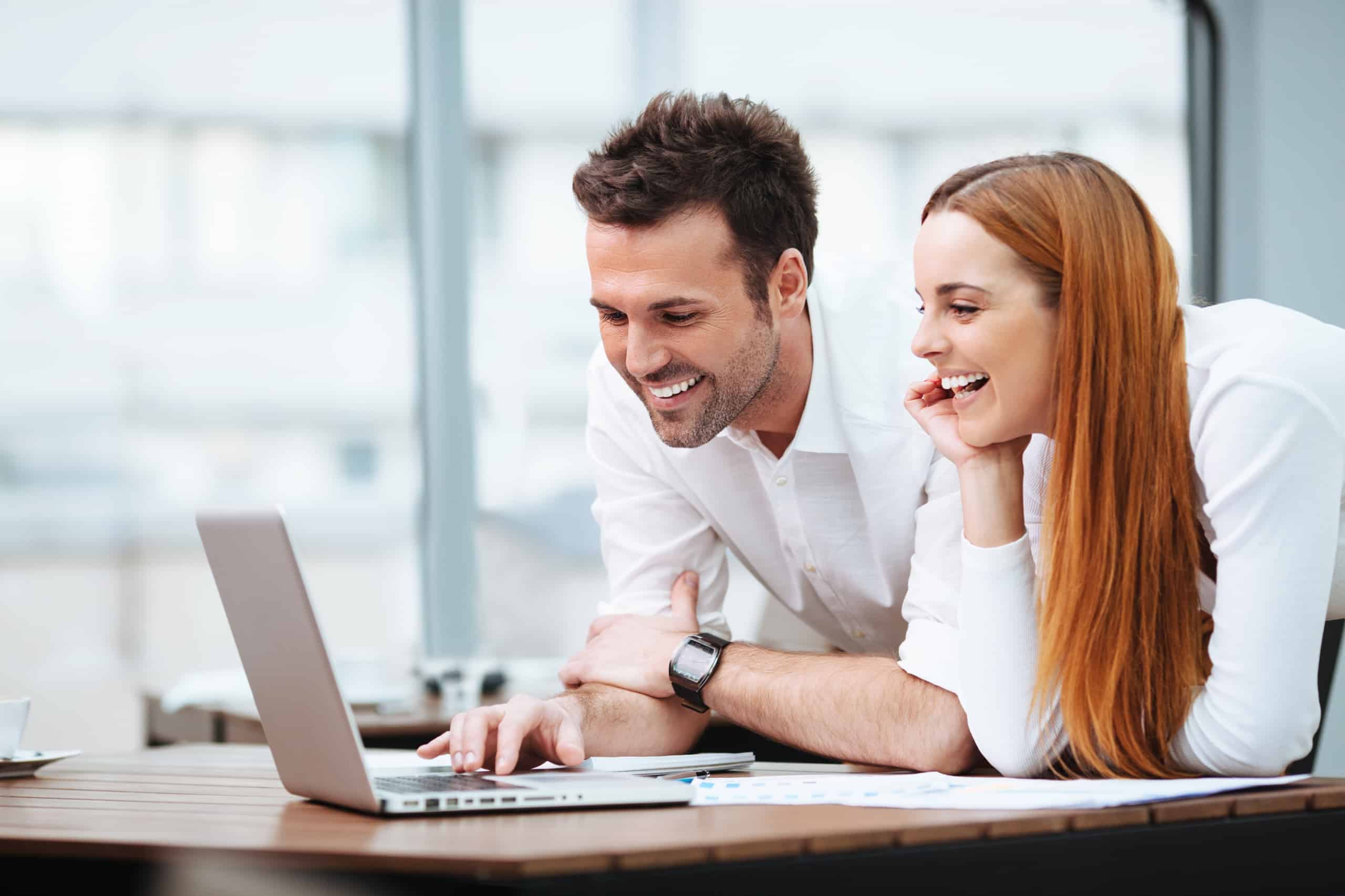 Two people looking at laptop