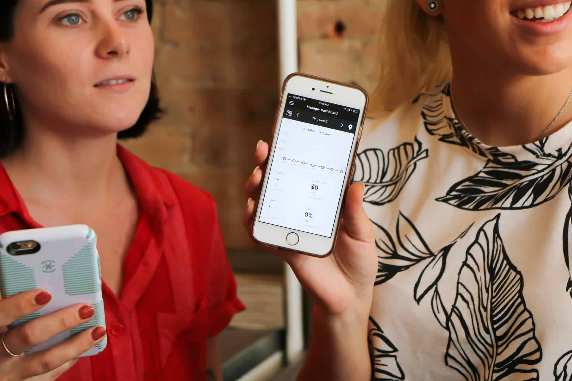 Two women holding phones