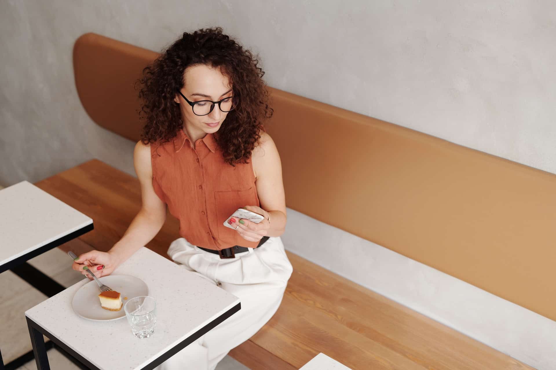 Woman looking at phone in café