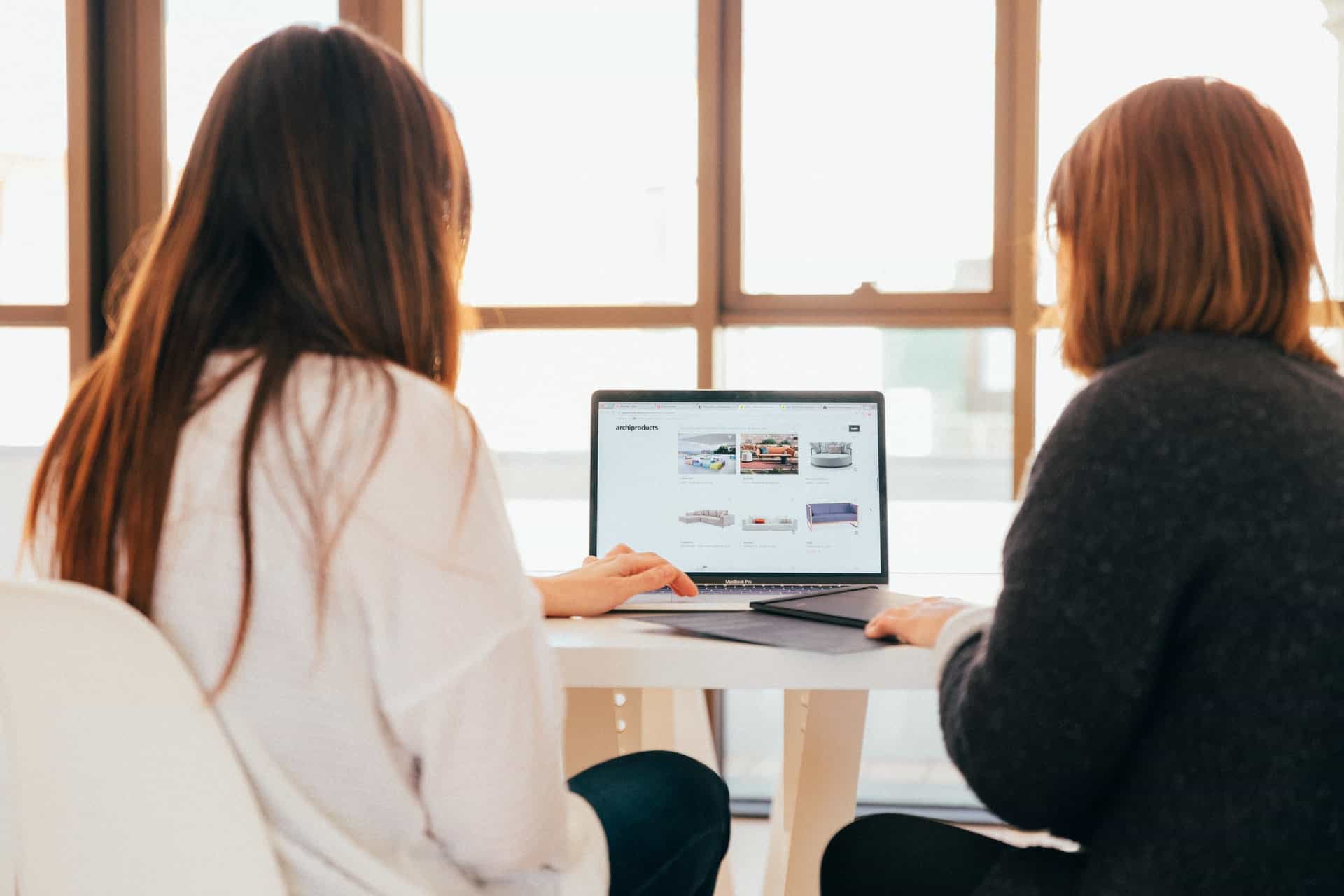 Women looking at website together