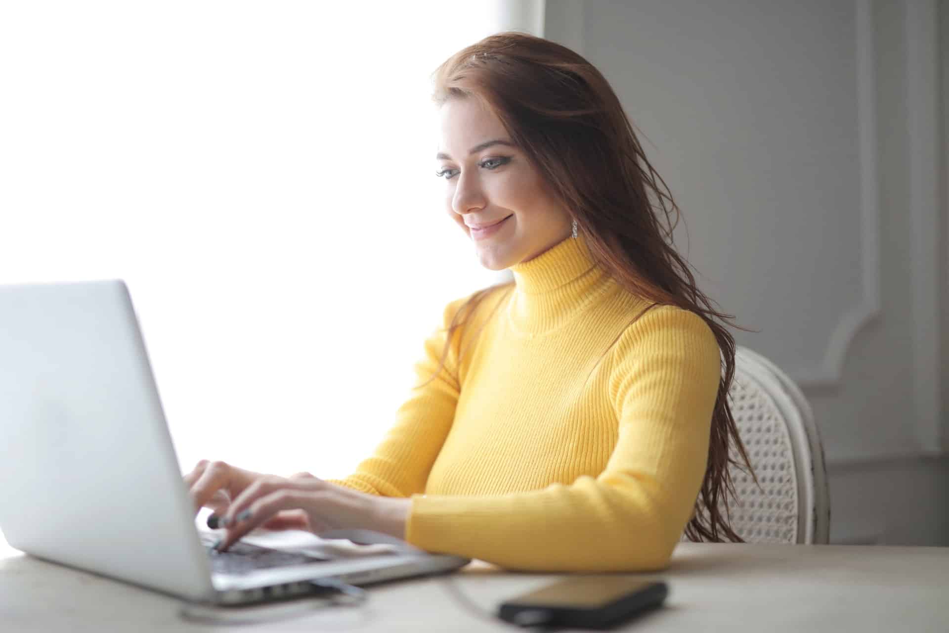 Happy woman using laptop