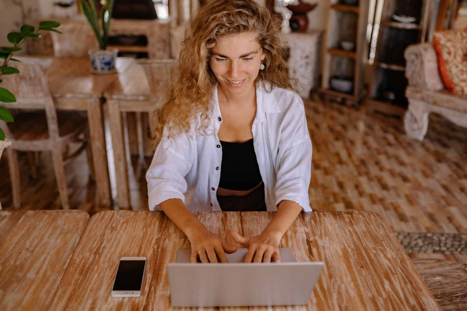 Woman using gray laptop
