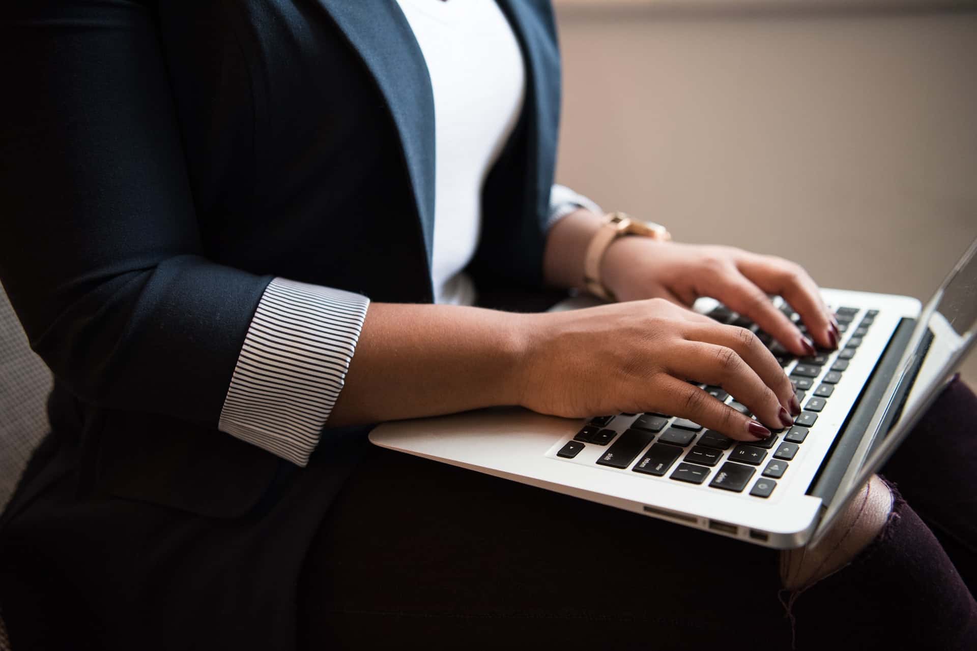 Woman with laptop in hand