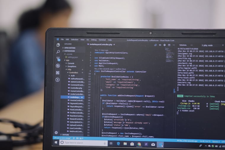 Code editor in dark mode open on laptop