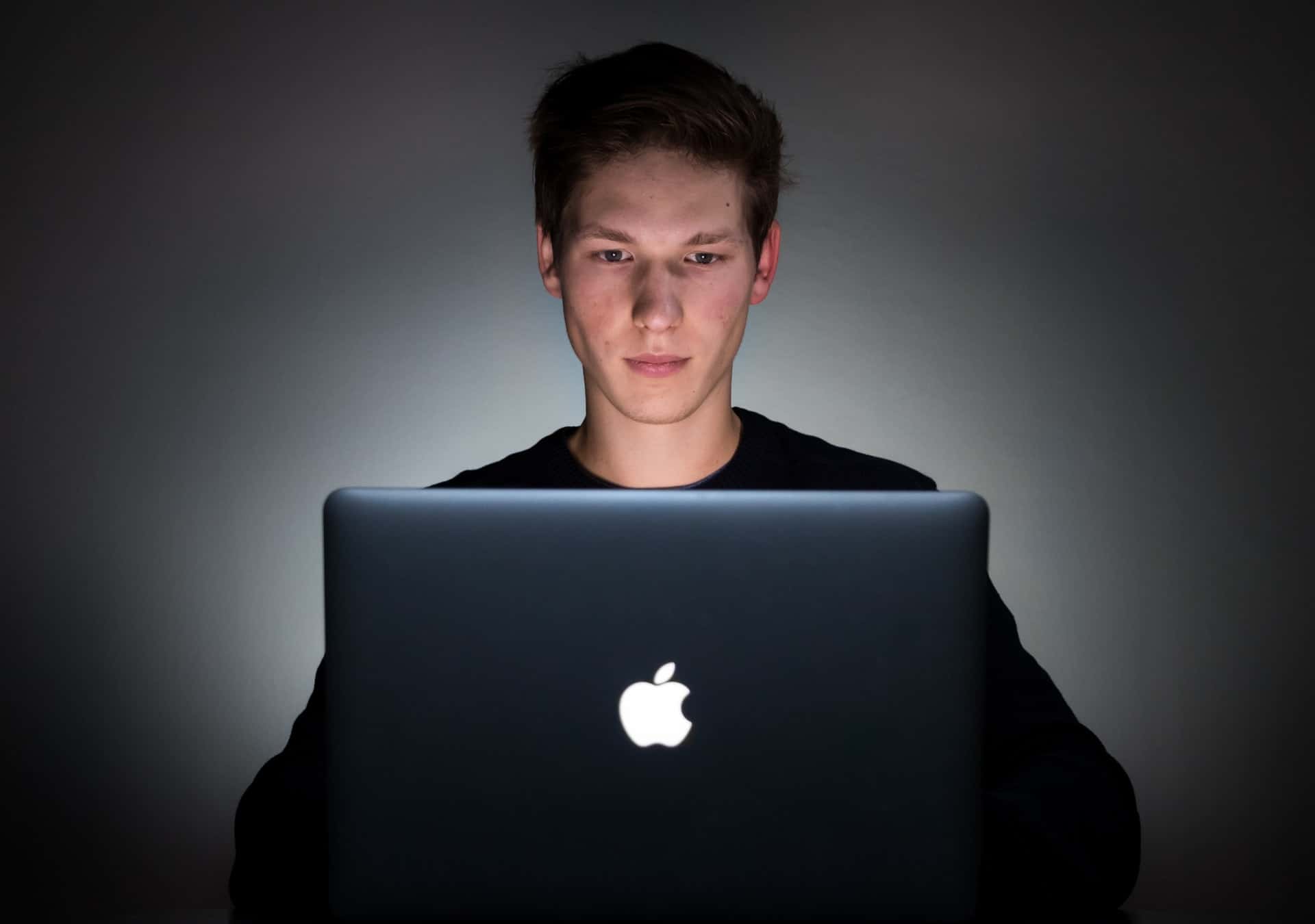 Man using laptop in the dark