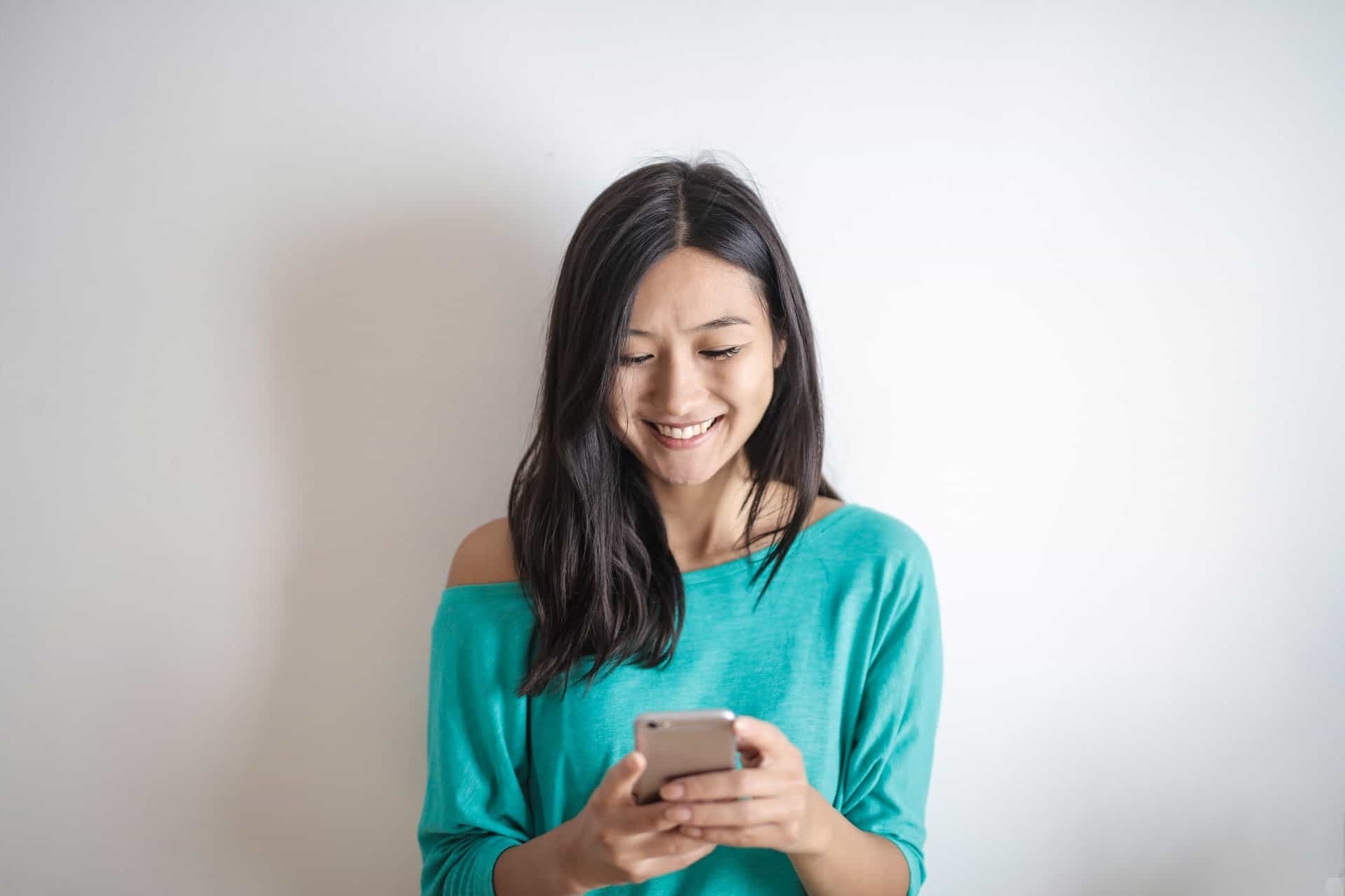 Woman smiling at her phone