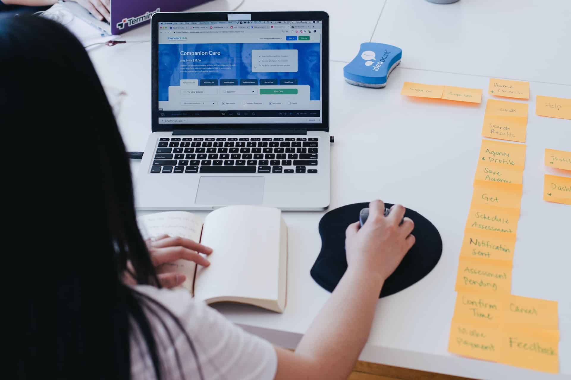 Woman using laptop and PC mouse