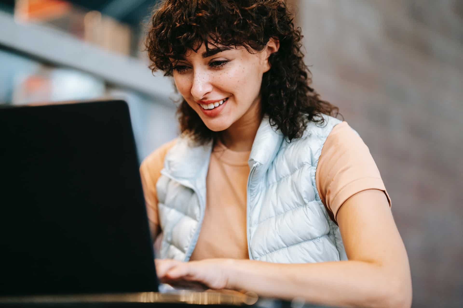 Girl smiling at laptop