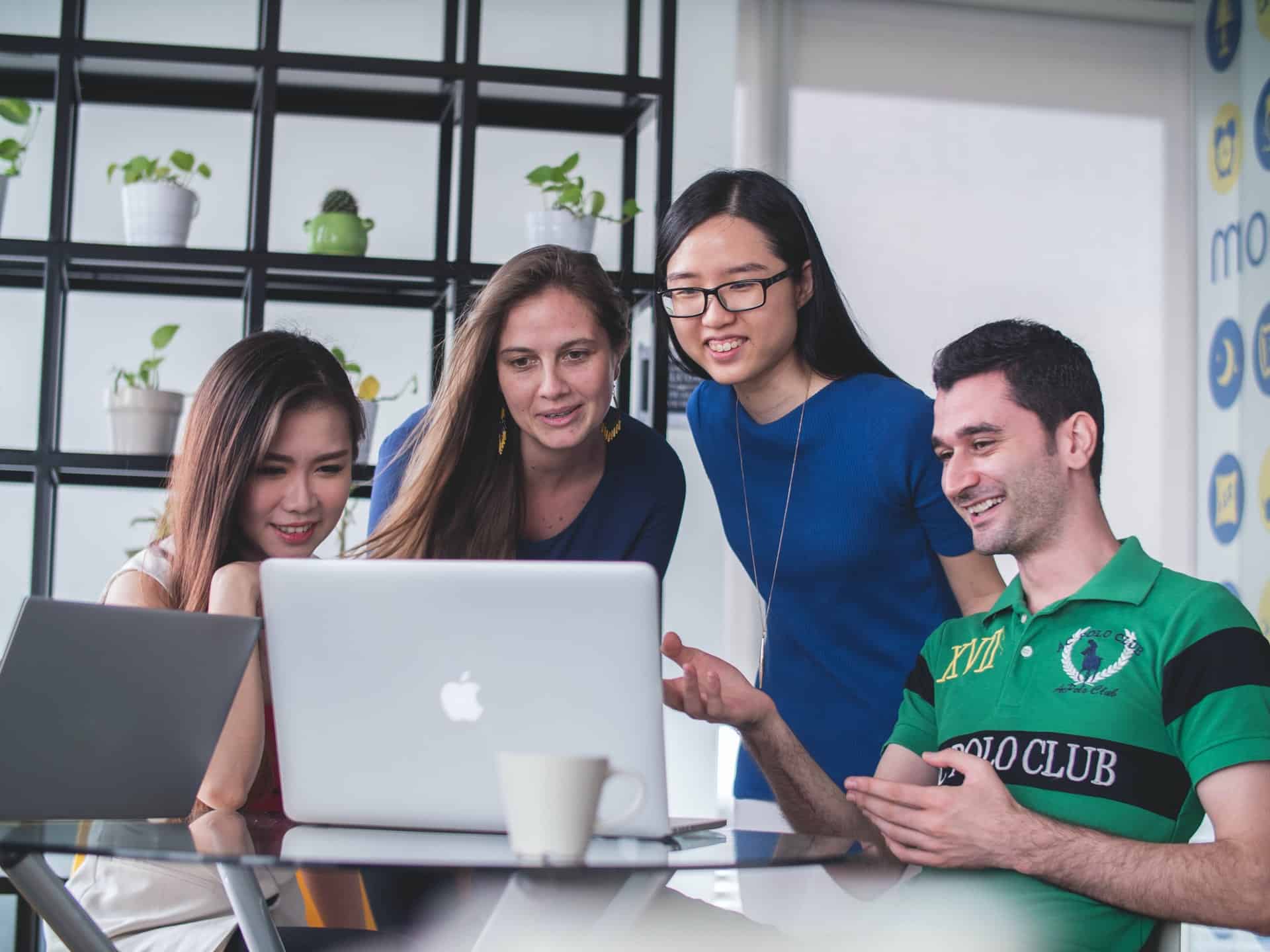 People looking at laptop together 