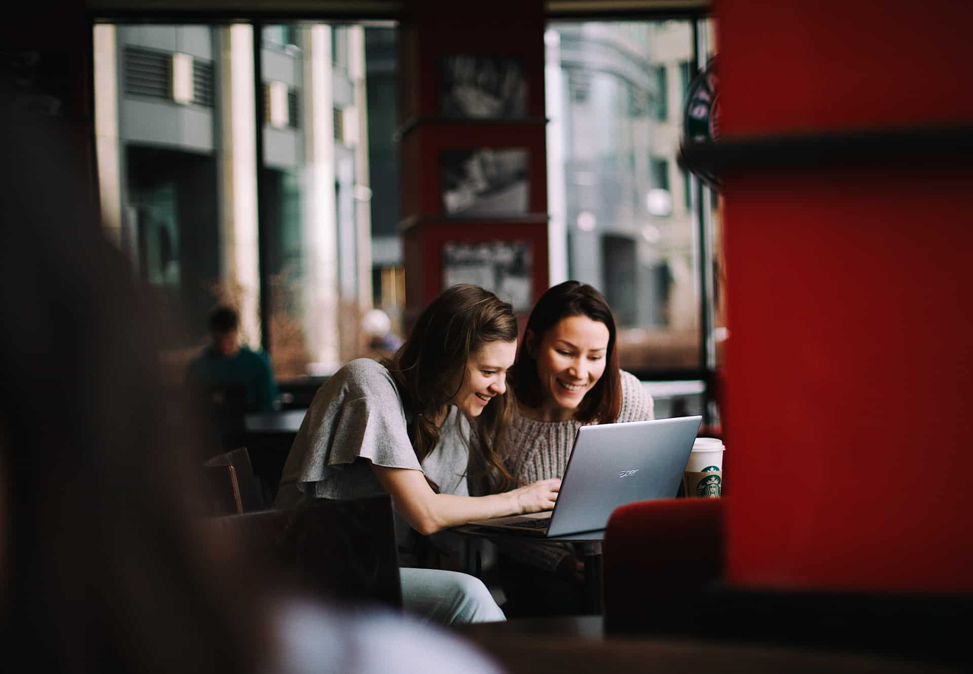 Two women looking at laptop together