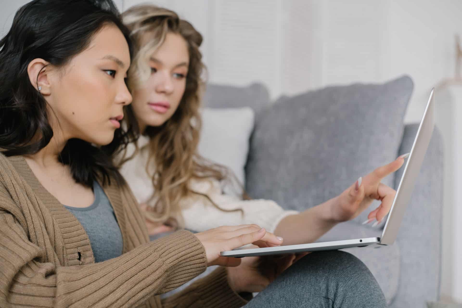 Two women looking at laptop