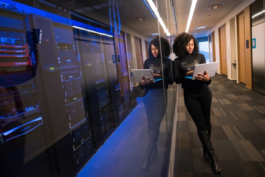 Girl standing with laptop in hands