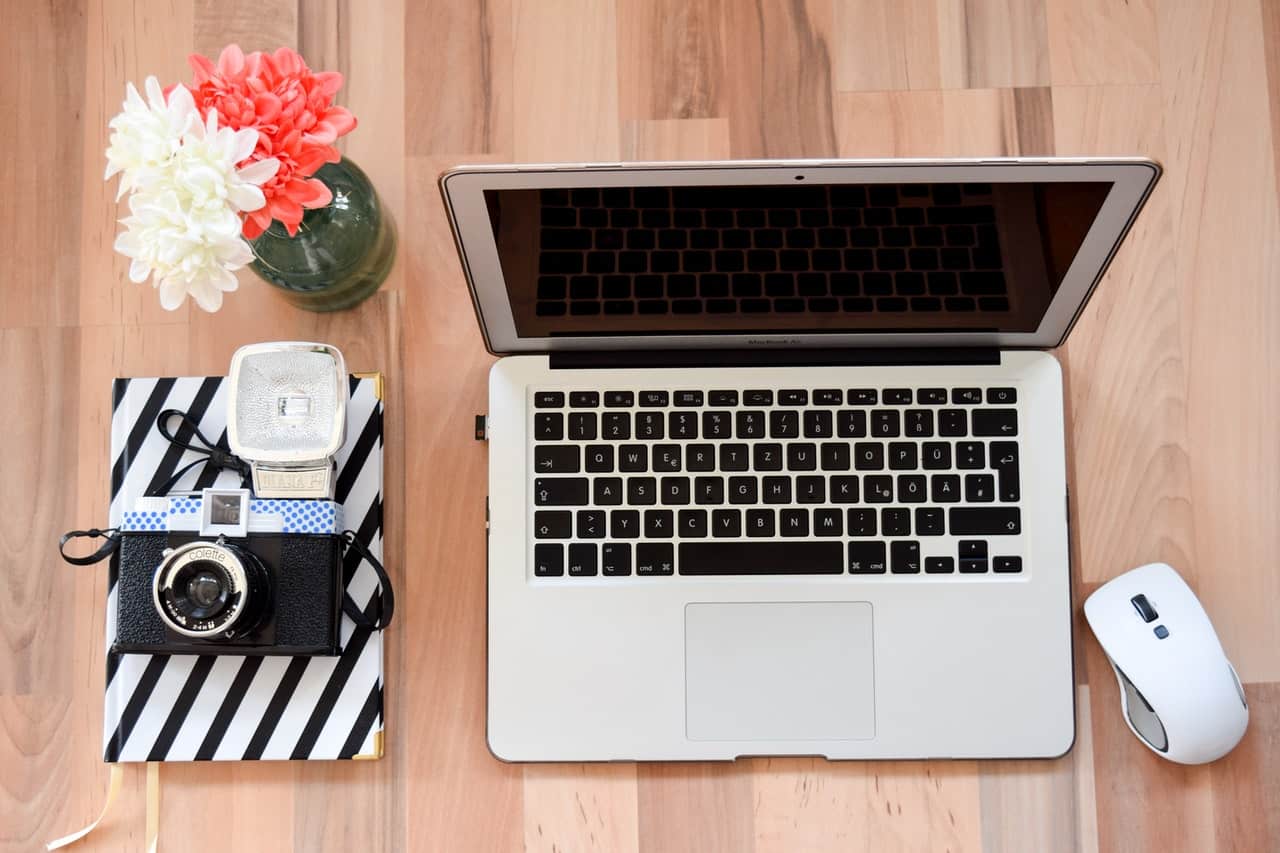 Laptop and camera on floor