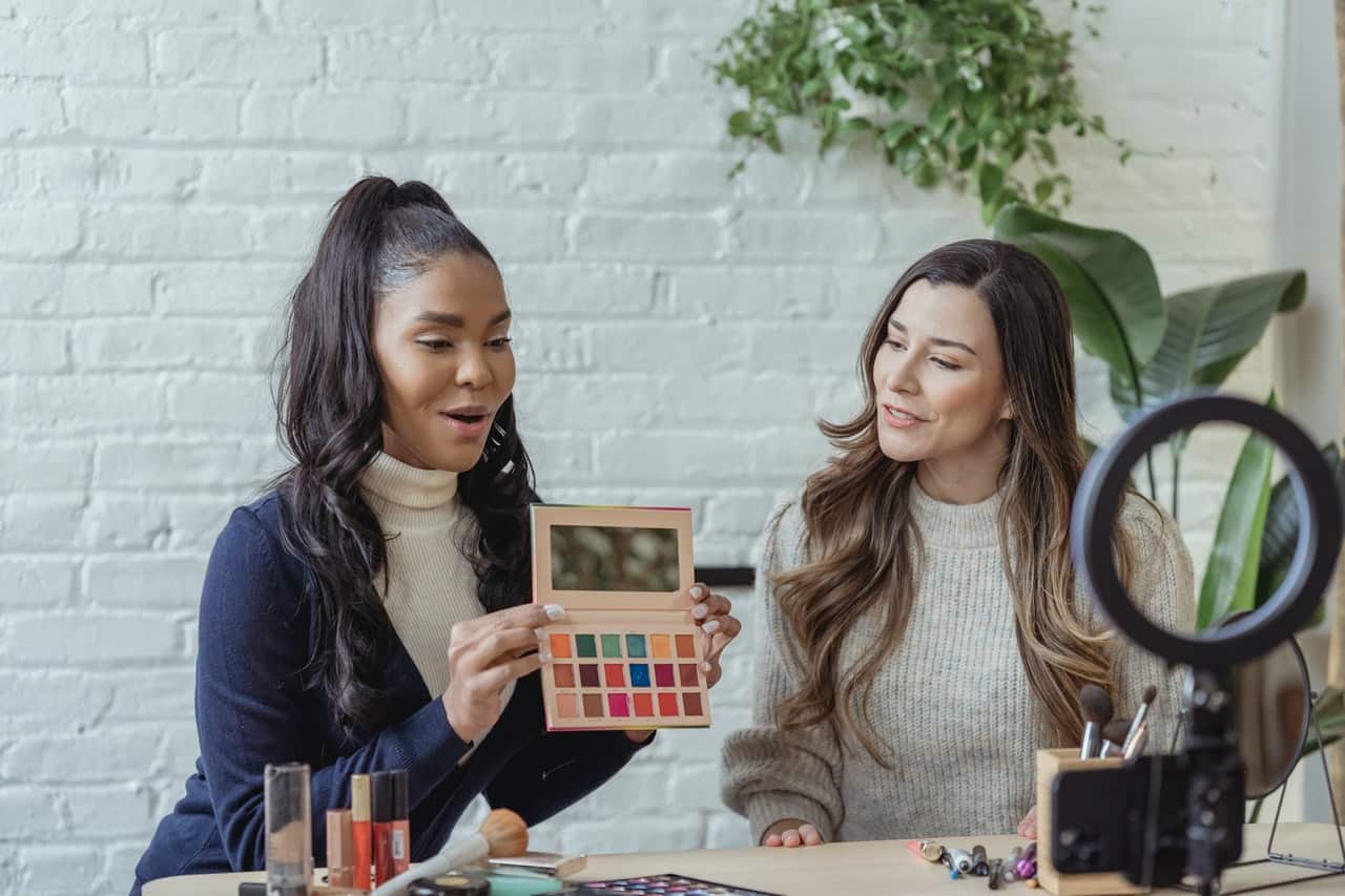 Two women filming product