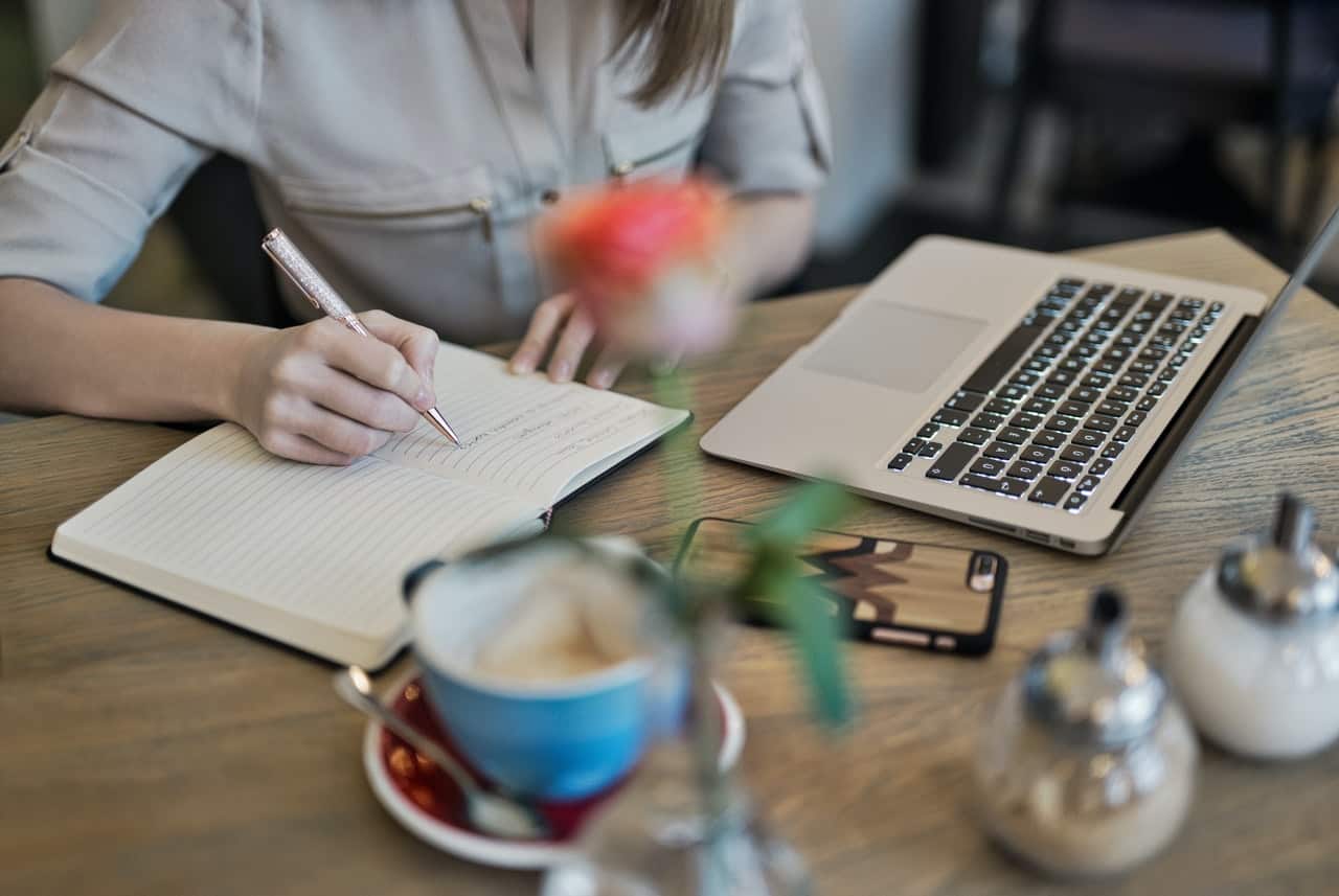 Person writing on a notebook