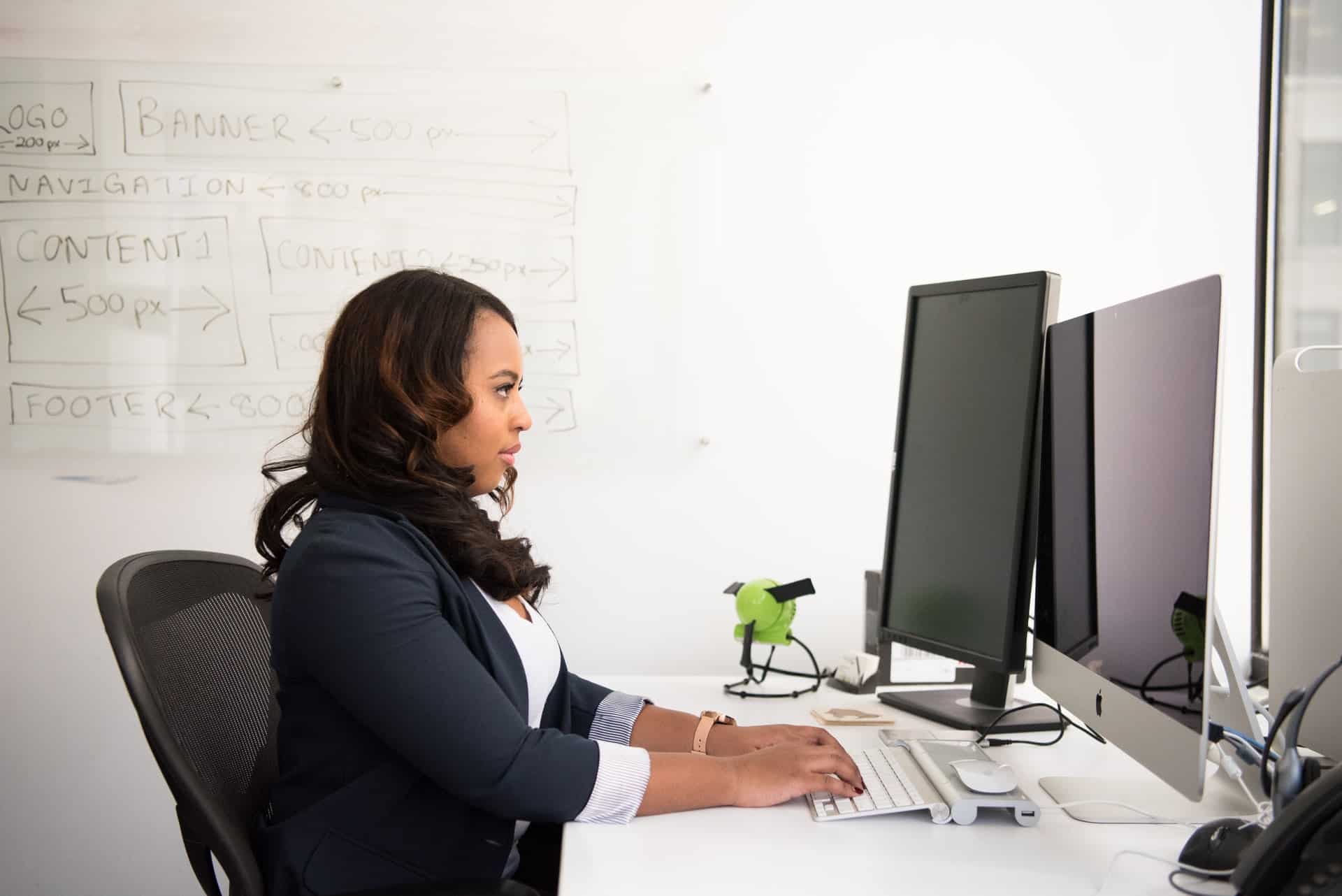 Woman sitting in front of monitor